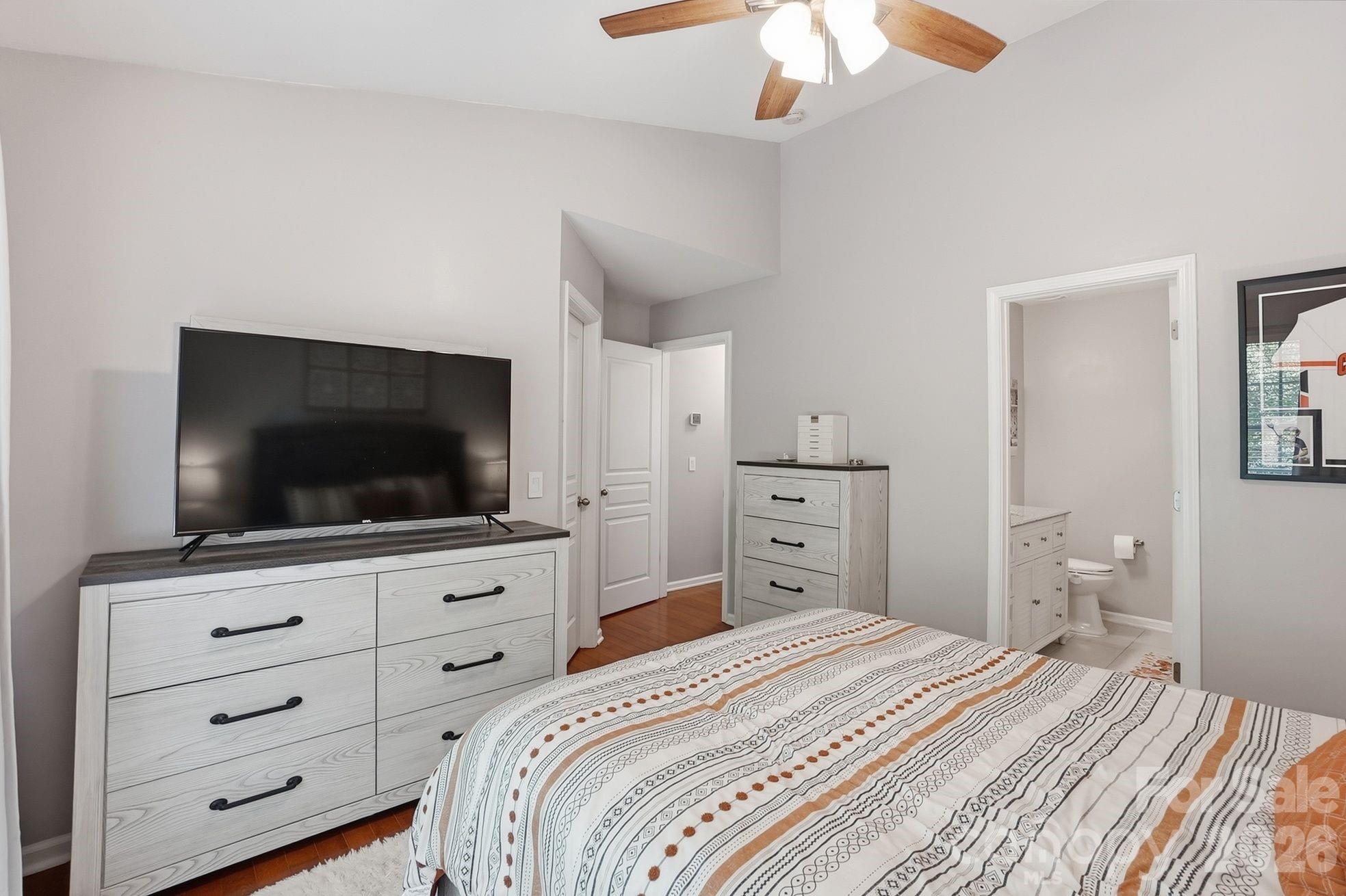 8512 Sunset Hill Road Waxhaw, NC 28173 - Photo 15 of 36 a bedroom with a bed and a flat screen tv