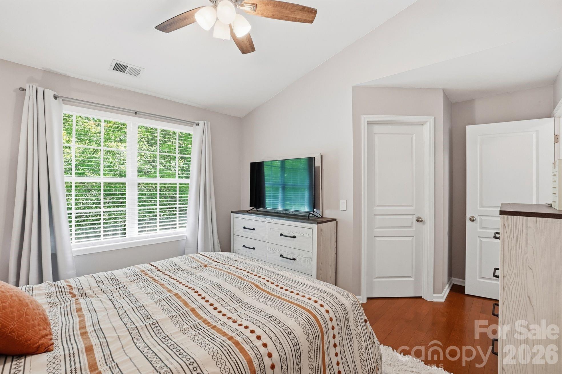 8512 Sunset Hill Road Waxhaw, NC 28173 - Photo 16 of 36 a bedroom with a bed and a flat screen tv