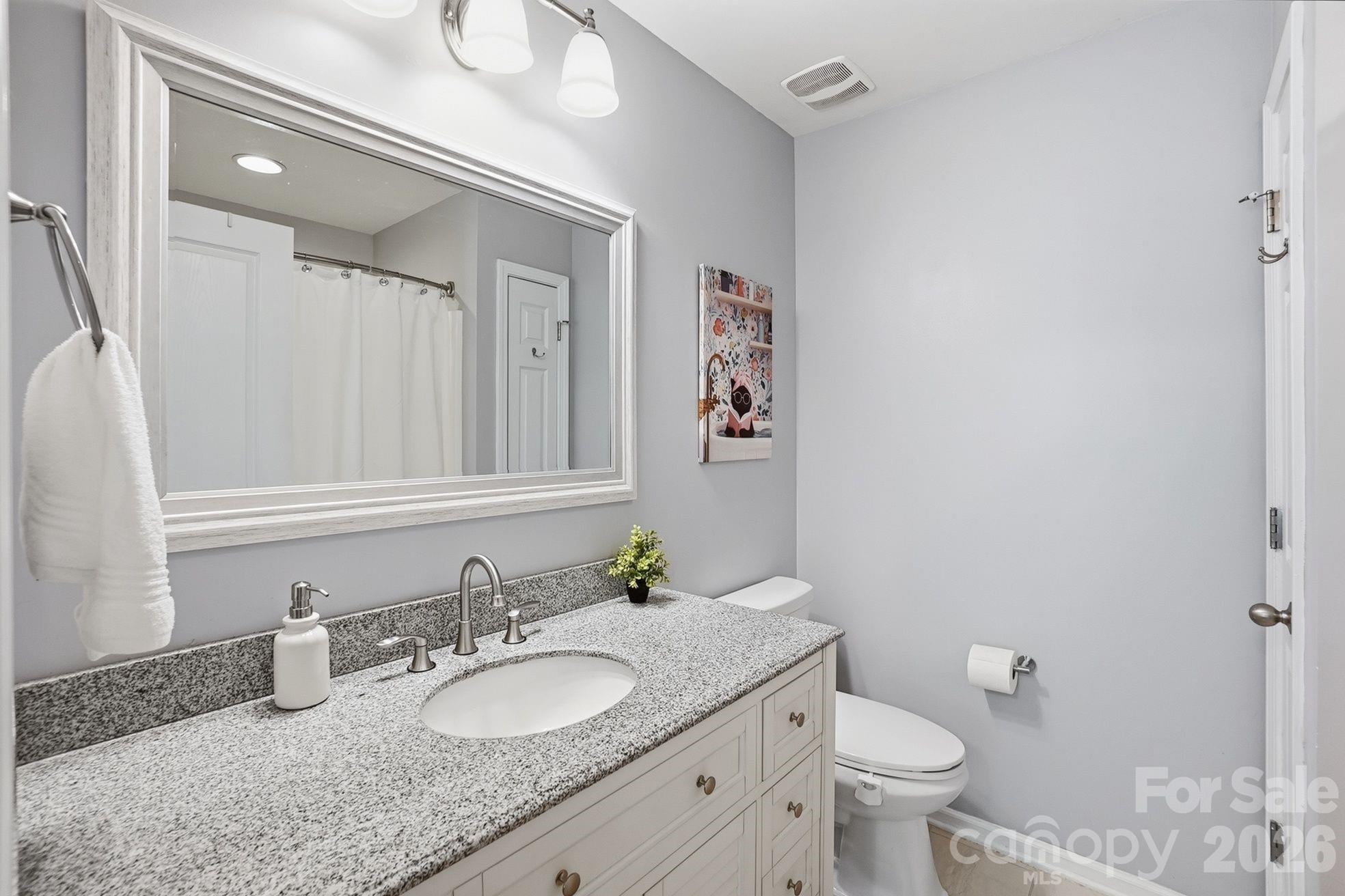8512 Sunset Hill Road Waxhaw, NC 28173 - Photo 20 of 36 a bathroom with a granite countertop sink and a mirror