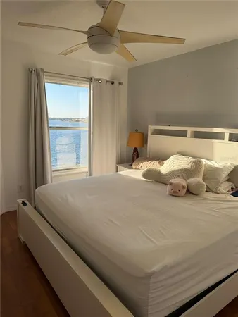 a large bed sitting in a bedroom next to a window