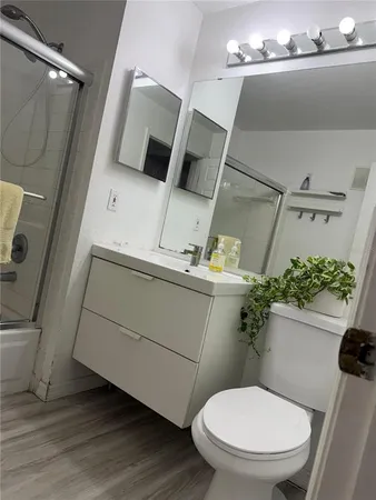 a white toilet sitting next to a small bathroom