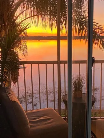 a view of balcony with floor to ceiling windows and yard