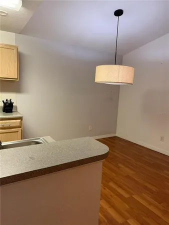 a kitchen with granite countertop a sink stove and refrigerator