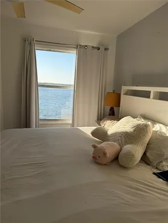 a large bed sitting in a bedroom next to a window