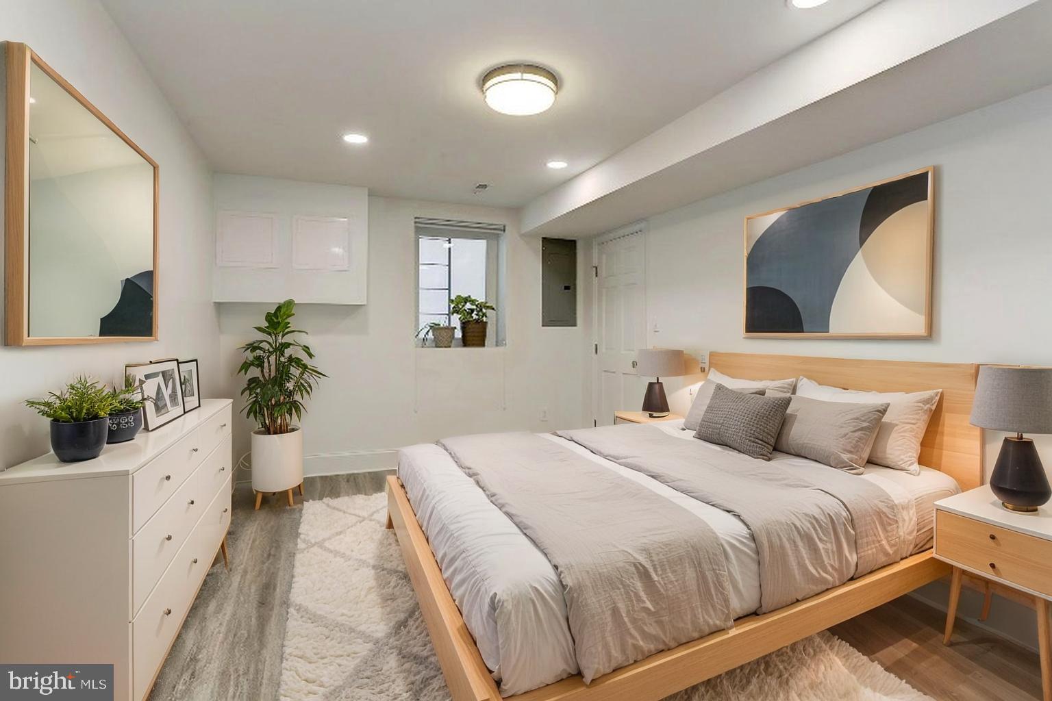 638 G Street Northeast Washington, DC 20002 - Photo 11 of 25 a bedroom with a large bed and a potted plant