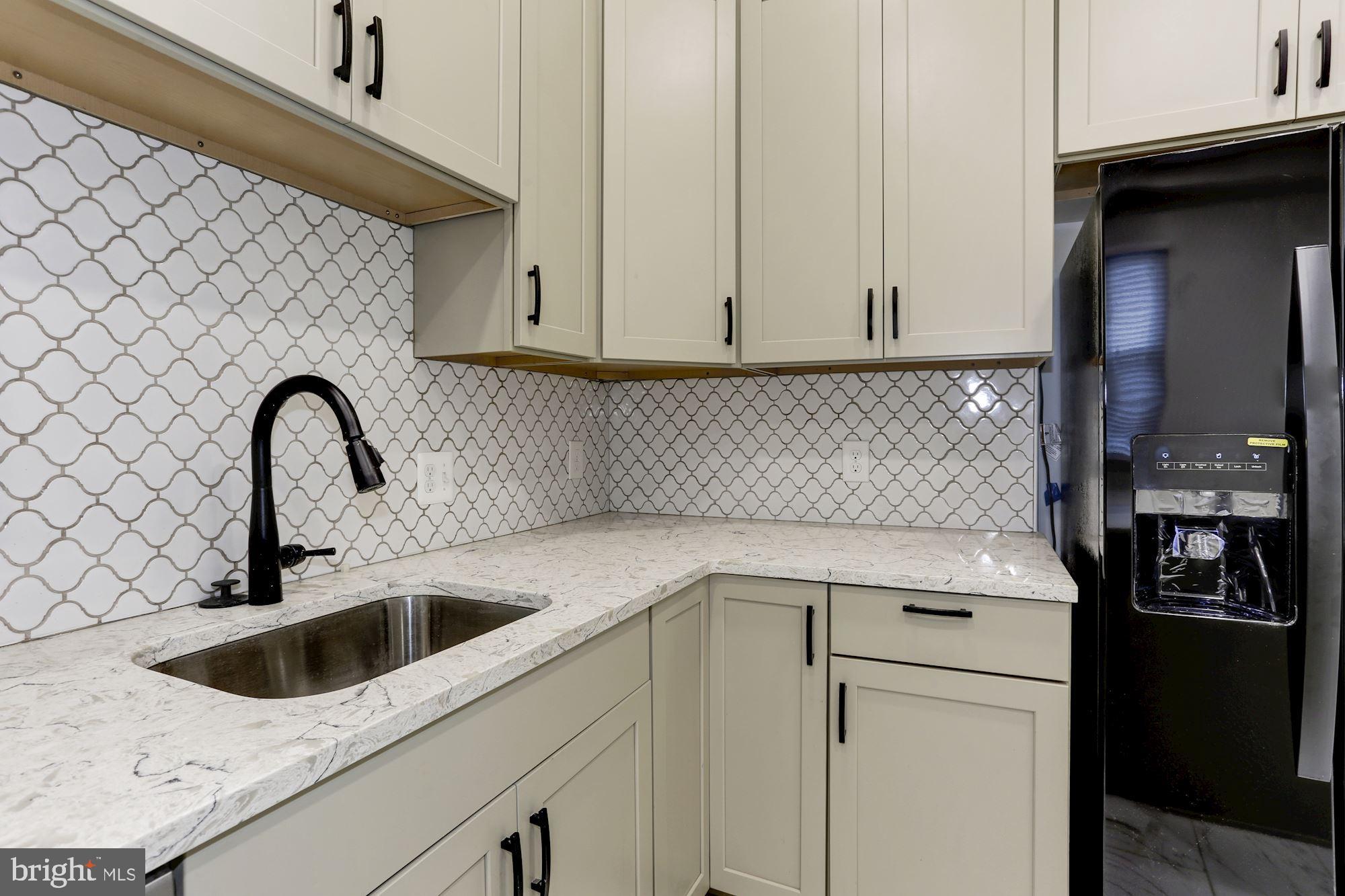 638 G Street Northeast Washington, DC 20002 - Photo 6 of 25 a kitchen with a sink and a refrigerator