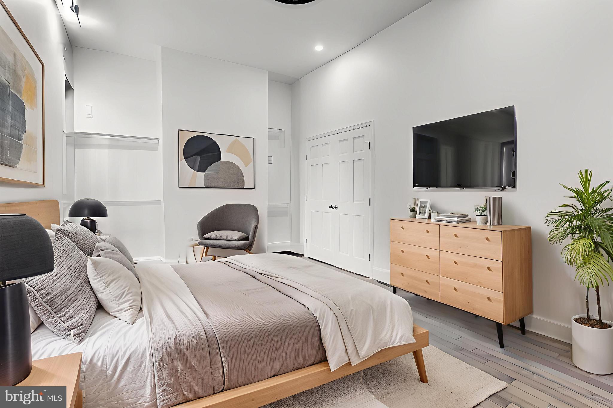 638 G Street Northeast Washington, DC 20002 - Photo 7 of 25 a bedroom with a bed and a flat screen tv