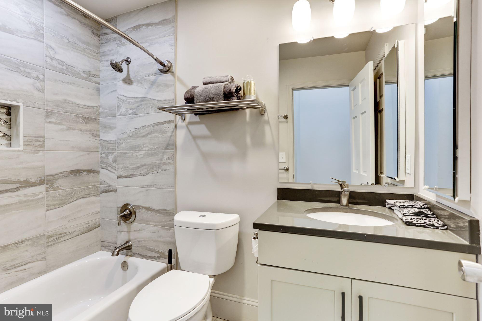 638 G Street Northeast Washington, DC 20002 - Photo 8 of 25 a bathroom with a granite countertop sink toilet and shower
