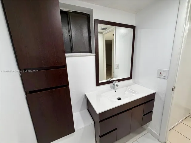 a bathroom with a sink and mirror