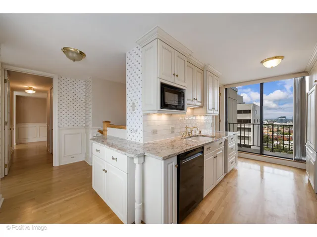 a kitchen with granite countertop a stove and a sink