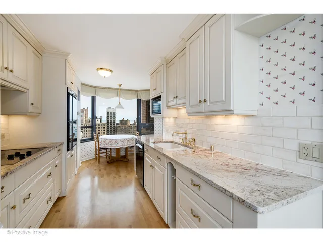 a kitchen with a sink a stove and cabinets