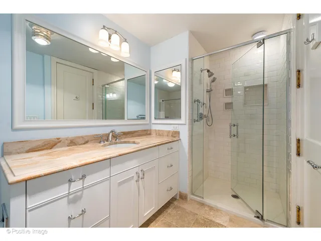 a bathroom with a granite countertop sink mirror and double