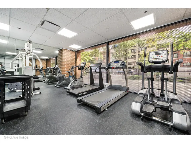 a room with gym equipment and a large window