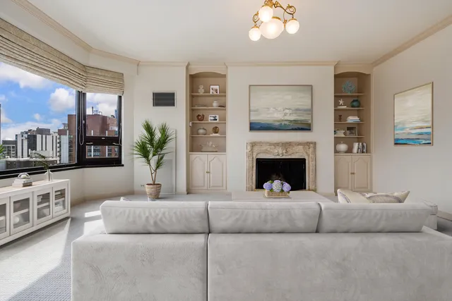 a living room with furniture and a fireplace