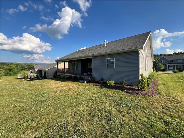 a view of a house with backyard and sitting area