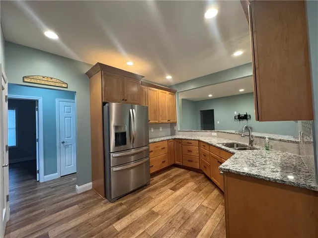a kitchen with a sink stove and refrigerator