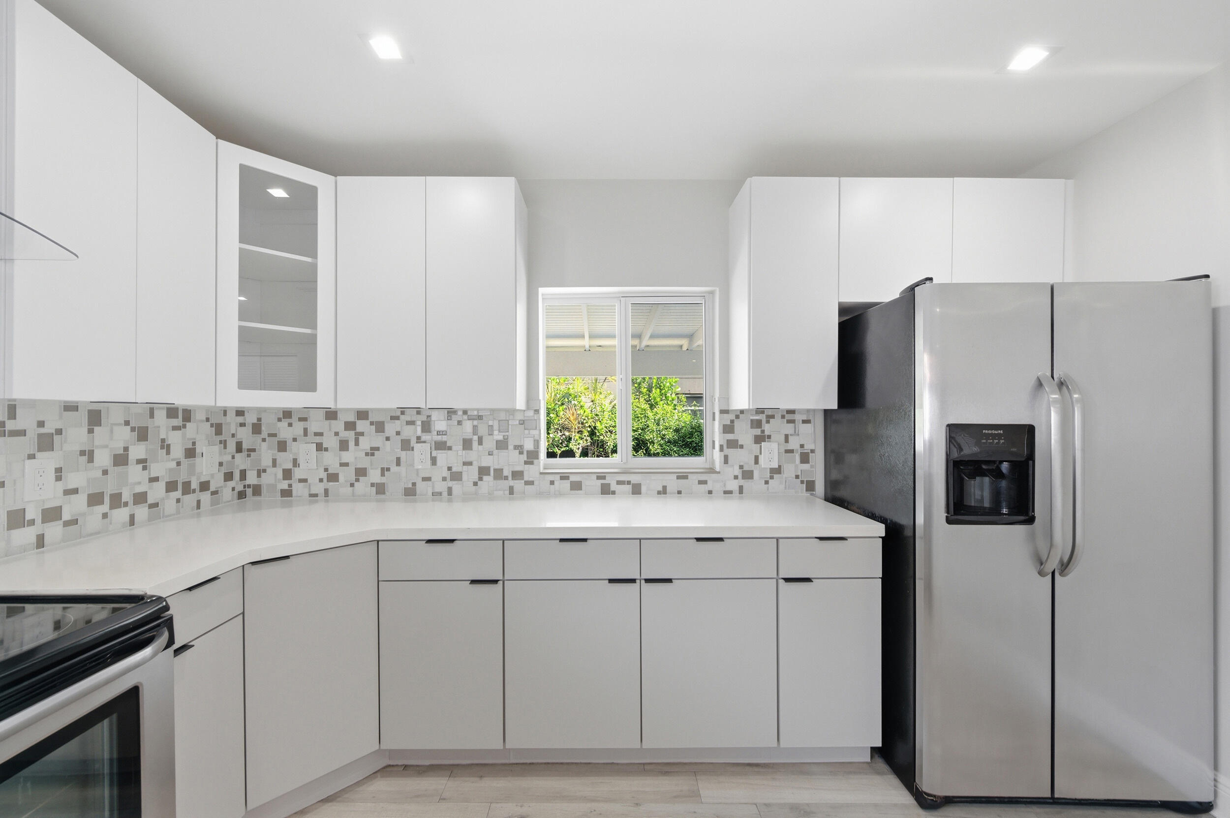 1770 Southwest 17th Avenue Miami, FL 33145 - Photo 16 of 46 a kitchen with granite countertop white cabinets and refrigerator