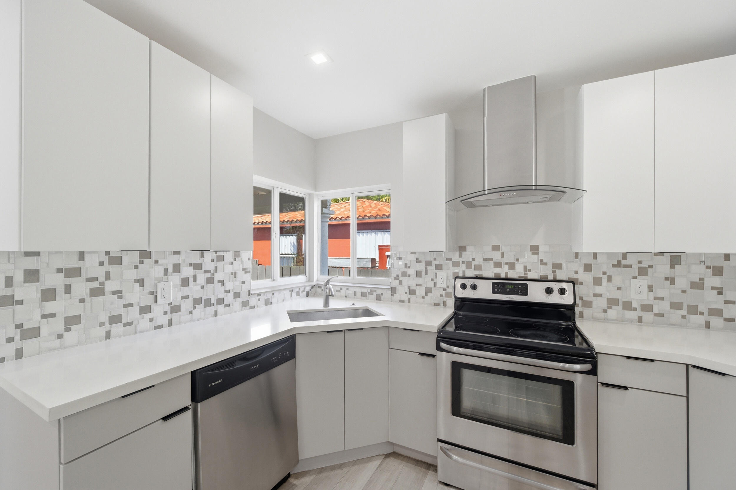 1770 Southwest 17th Avenue Miami, FL 33145 - Photo 18 of 46 a kitchen with stainless steel appliances a stove and white cabinets