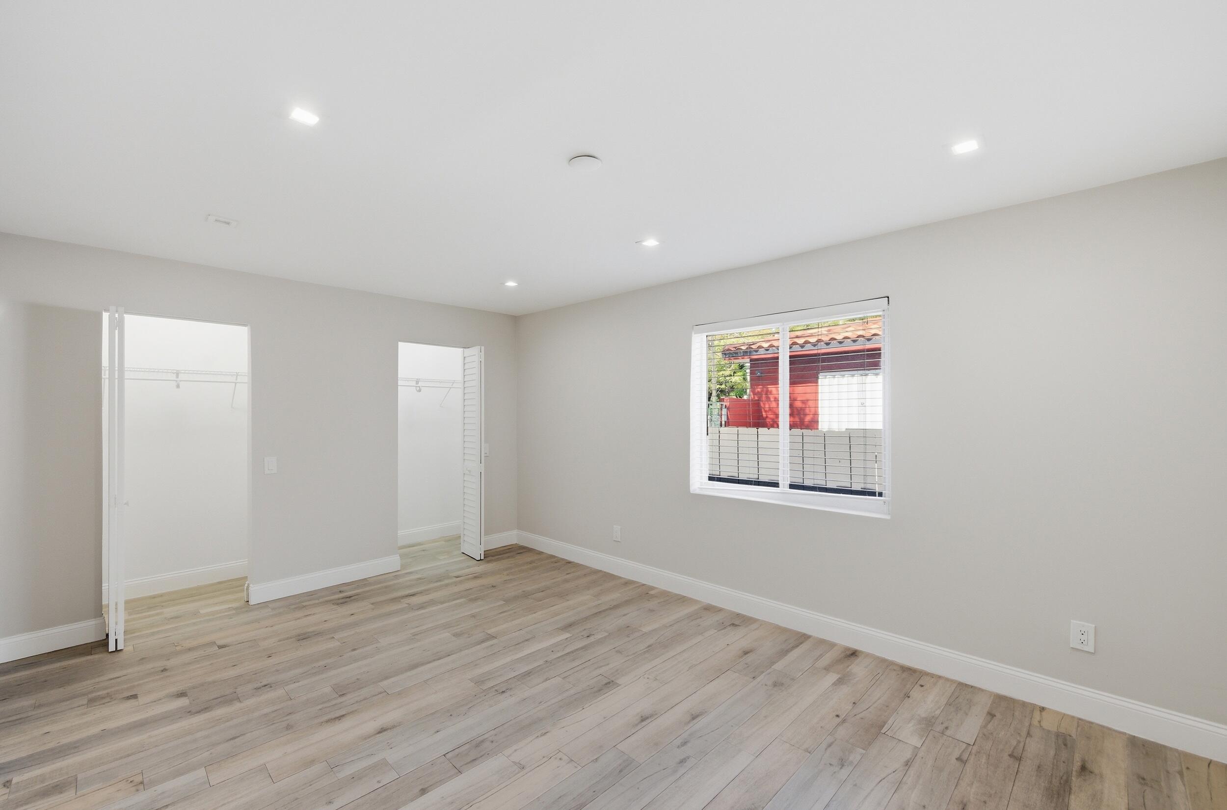 1770 Southwest 17th Avenue Miami, FL 33145 - Photo 20 of 46 an empty room with wooden floor and windows
