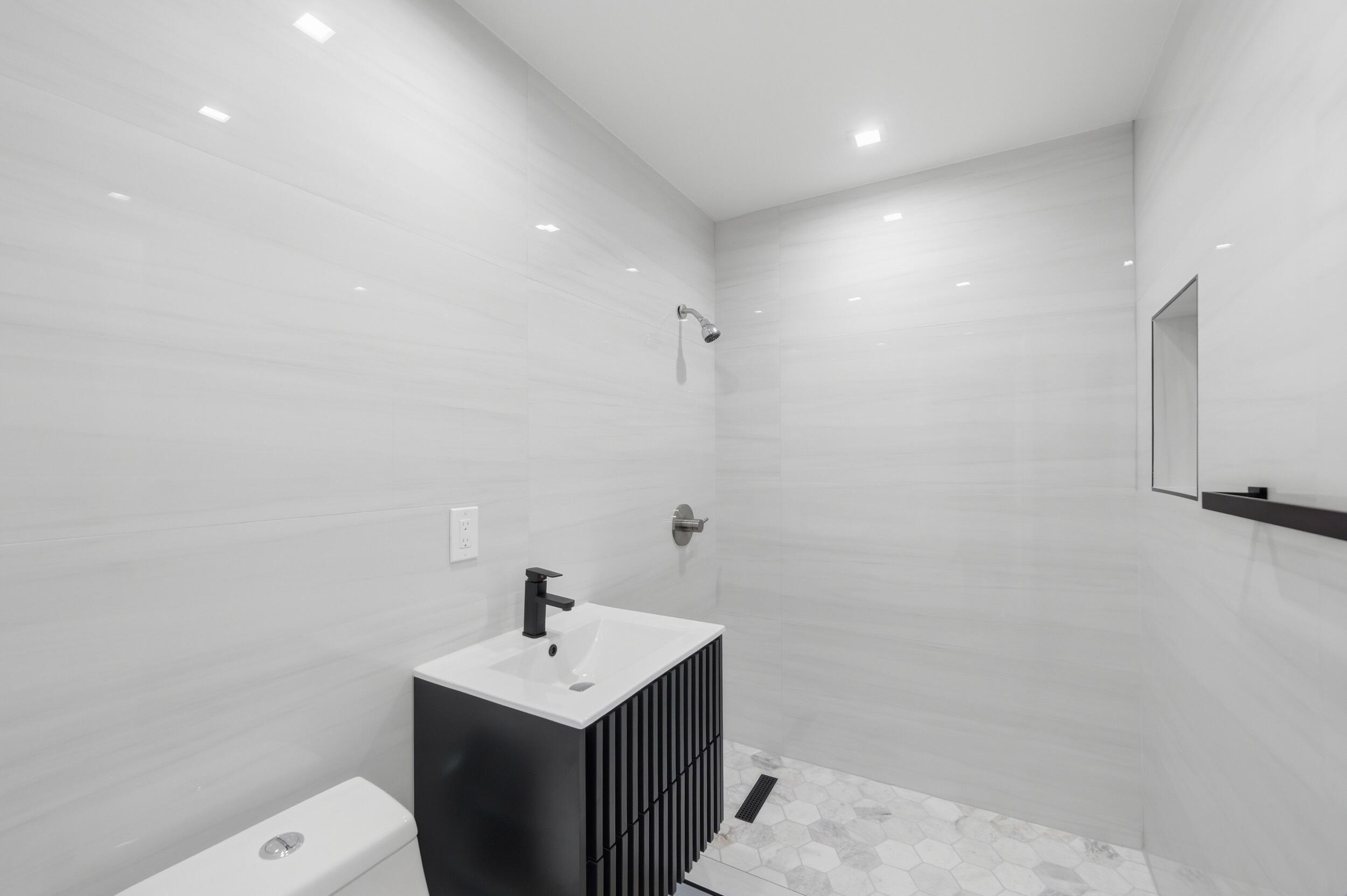 1770 Southwest 17th Avenue Miami, FL 33145 - Photo 26 of 46 a bathroom with a sink a toilet and a mirror