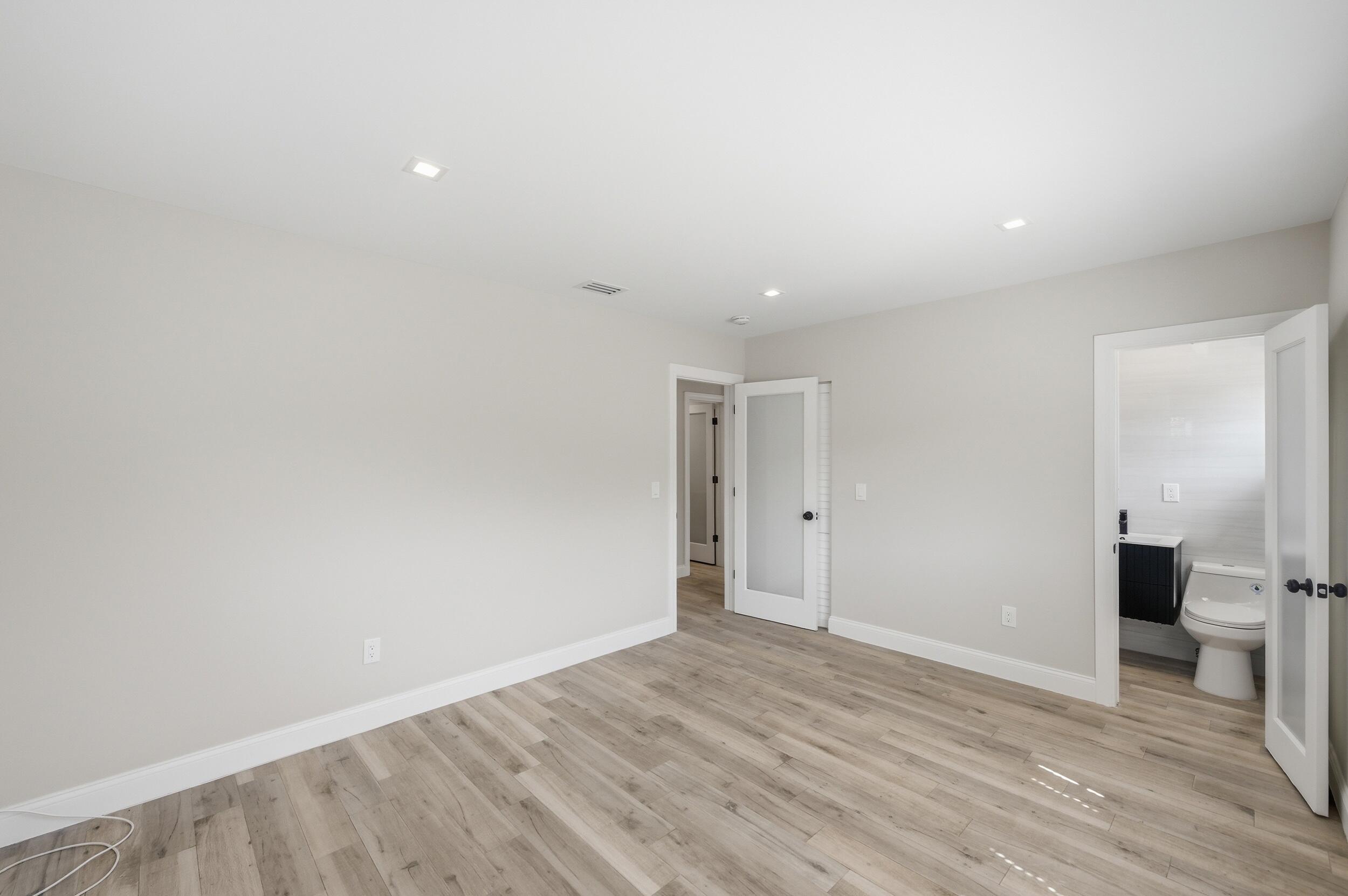 1770 Southwest 17th Avenue Miami, FL 33145 - Photo 28 of 46 a view of an empty room with wooden floor and a bathroom