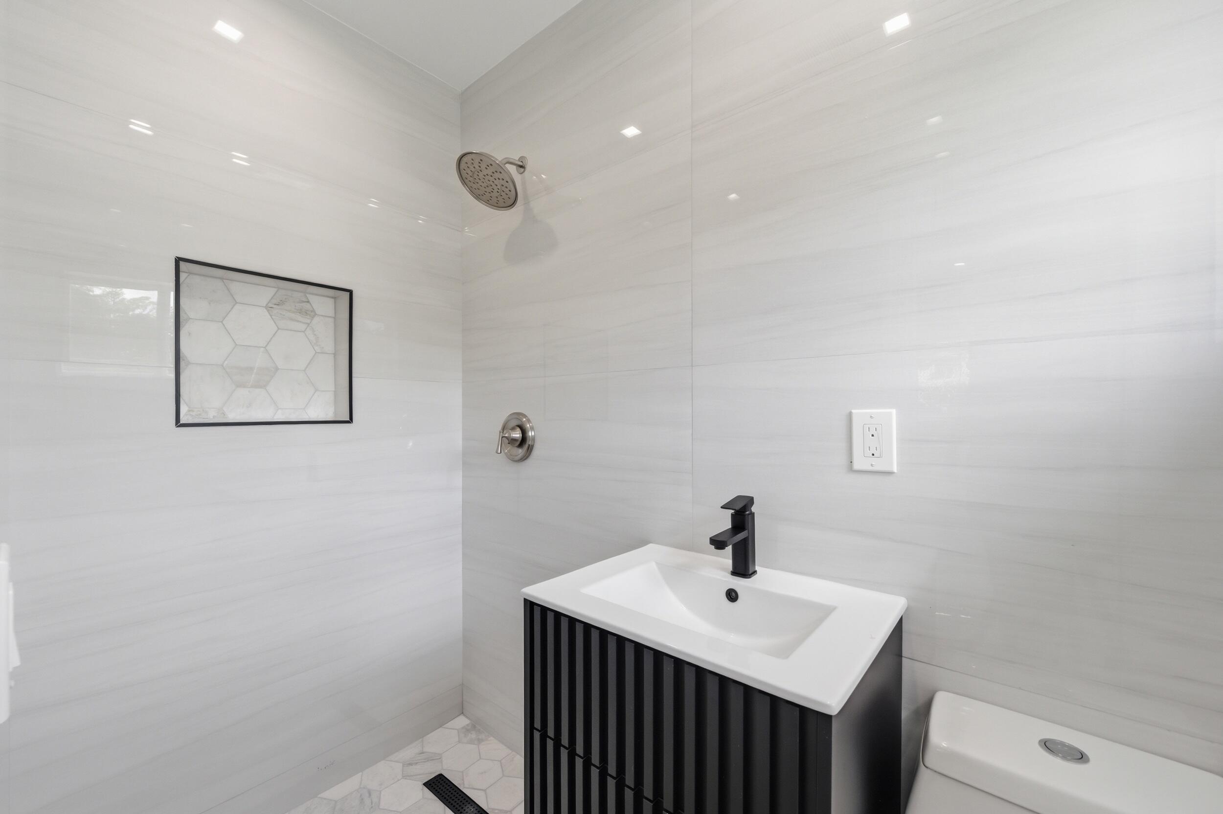 1770 Southwest 17th Avenue Miami, FL 33145 - Photo 29 of 46 a bathroom with a sink a toilet and mirror