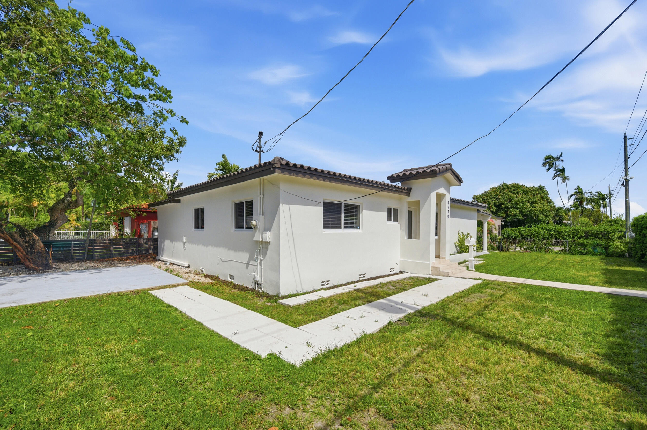 1770 Southwest 17th Avenue Miami, FL 33145 - Photo 3 of 46 a view of a house with a yard and a porch