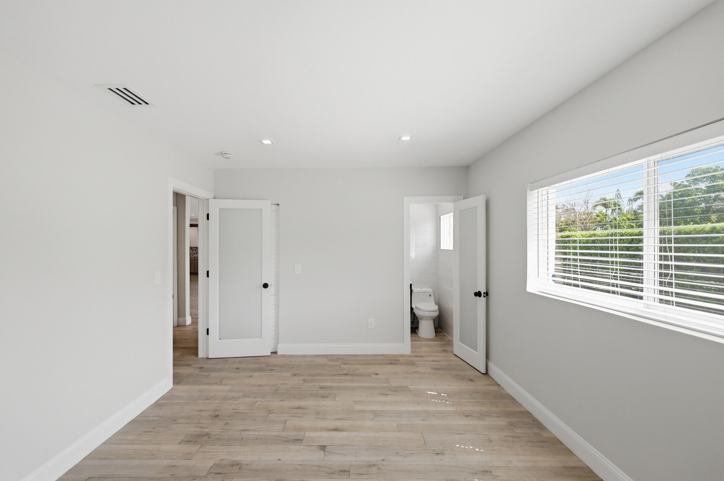 1770 Southwest 17th Avenue Miami, FL 33145 - Photo 34 of 46 a view of an empty room with wooden floor and a window