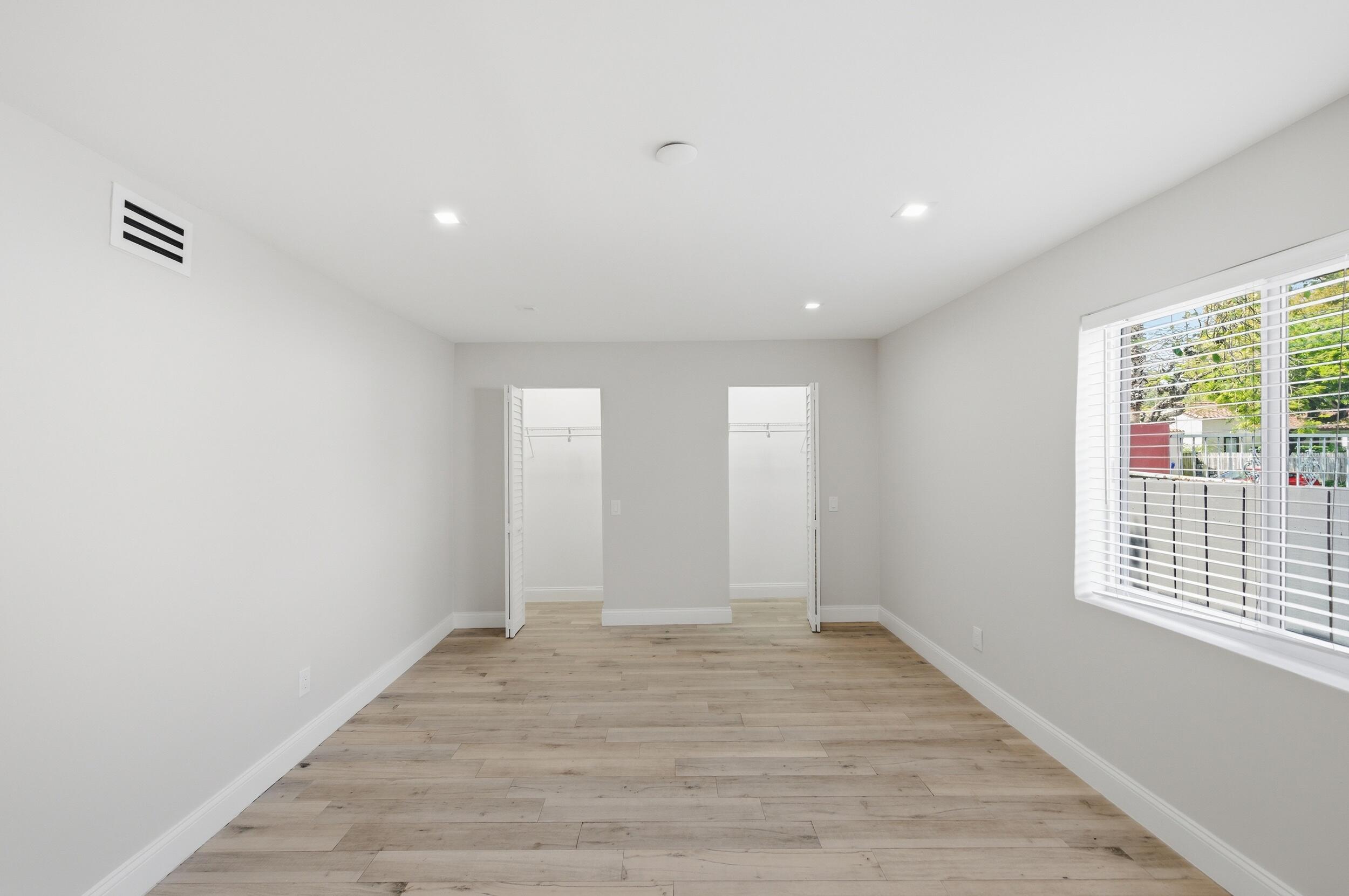 1770 Southwest 17th Avenue Miami, FL 33145 - Photo 36 of 46 a view of an empty room with wooden floor and a window