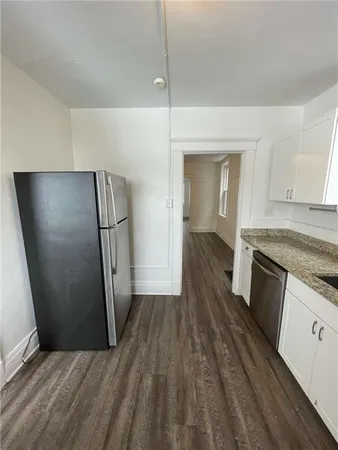 a view of a kitchen from wooden floor