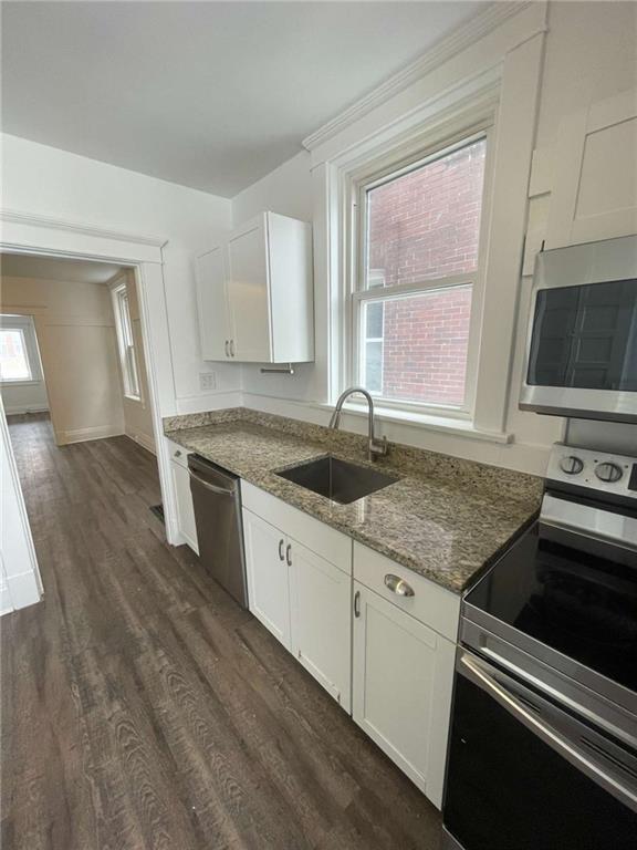 136 South Spring Avenue Greensburg, PA 15601 - Photo 18 of 46 a kitchen with granite countertop a sink cabinets stainless steel appliances and a window
