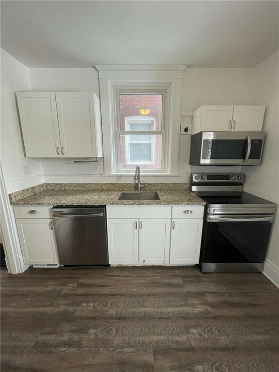136 South Spring Avenue Greensburg, PA 15601 - Photo 20 of 46 a white kitchen with granite countertop a stove and a sink