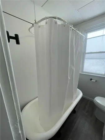 a bathroom with a toilet a sink and mirror