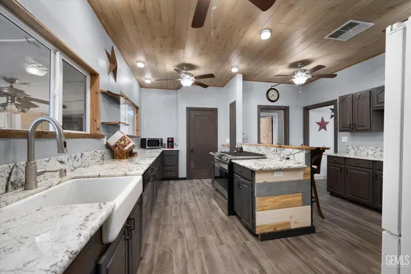 a kitchen with stainless steel appliances granite countertop a sink stove and refrigerator