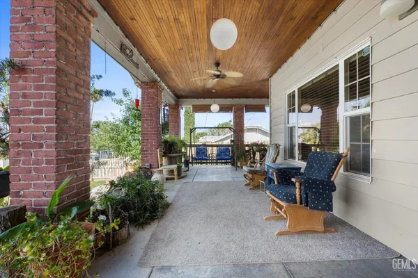 a building outdoor space with patio furniture and potted plants