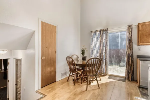 a dining room with furniture and wooden floor