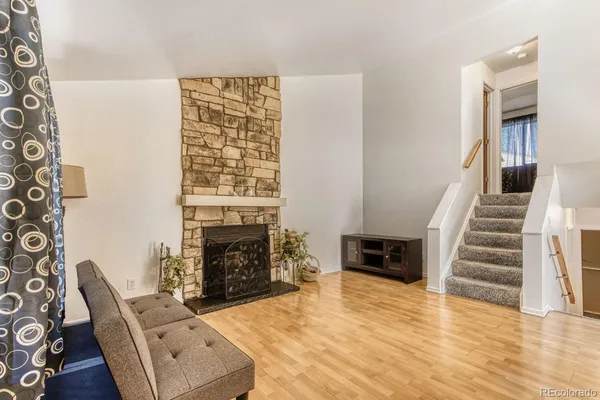 a living room with furniture and a fireplace