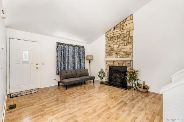a living room with furniture and a fireplace