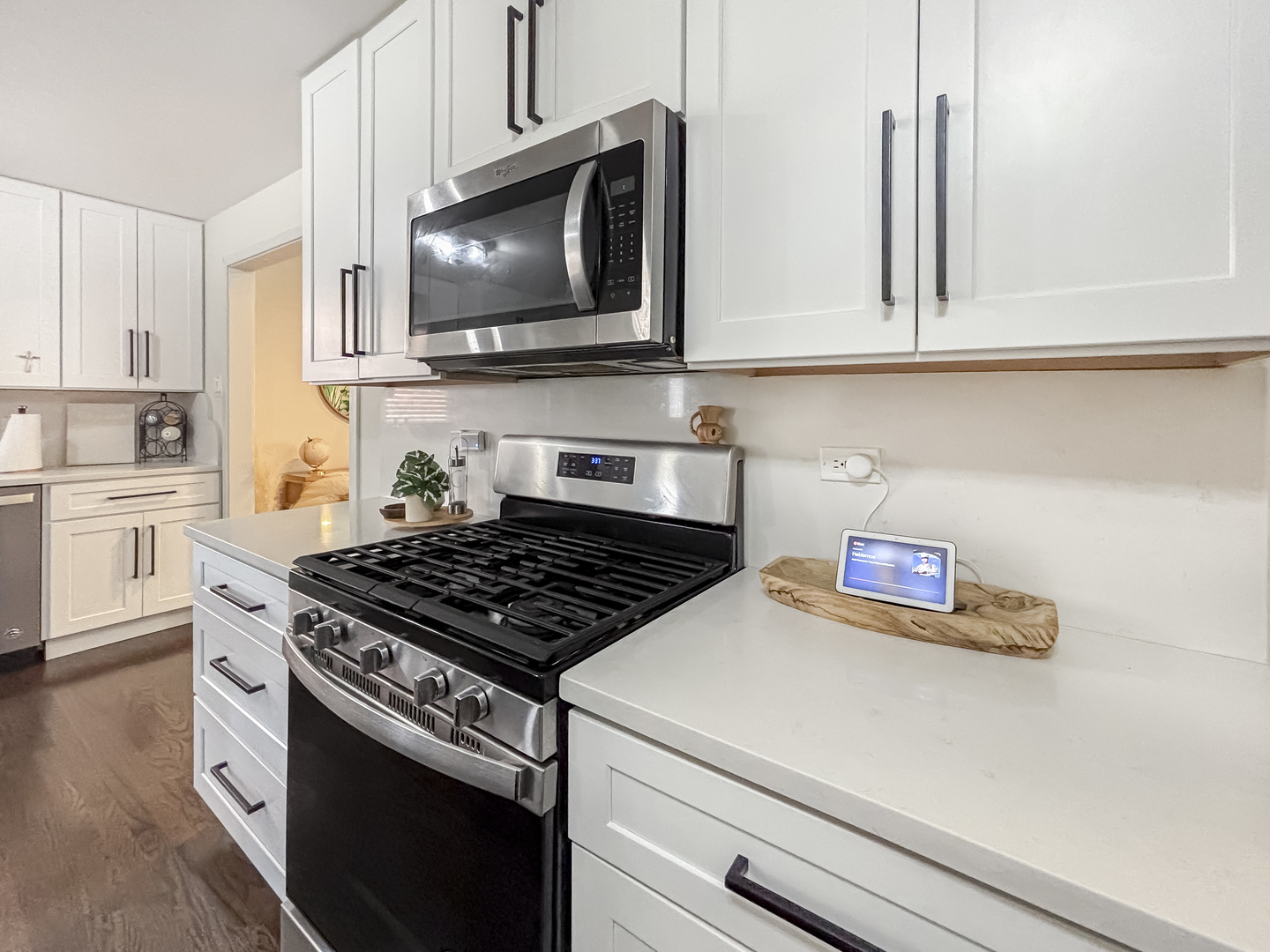 8538 45th Street Lyons, IL 60534 - Photo 17 of 29 a kitchen with stainless steel appliances a stove a microwave and cabinets