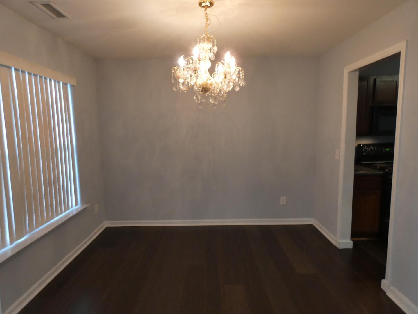 1624 Brown Owl Drive Raleigh, NC 27610 - Photo 4 of 22 wooden floor in an empty room with a window