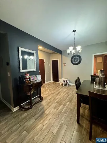 a bed room with a bed mirror and a chandelier