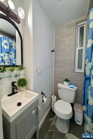 a bathroom with a sink mirror and toilet