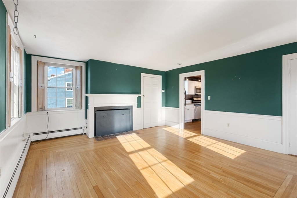 14 Mall Street, Unit B Salem, MA 01970 - Photo 16 of 30 a view of a livingroom with wooden floor and a fireplace
