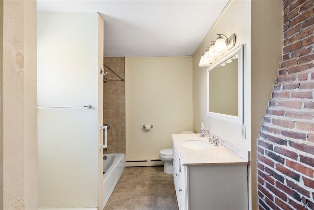 14 Mall Street, Unit B Salem, MA 01970 - Photo 23 of 30 a bathroom with a sink a mirror and a shower