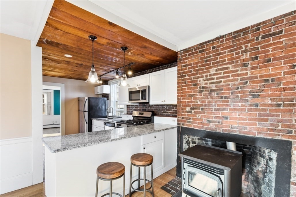 14 Mall Street, Unit B Salem, MA 01970 - Photo 9 of 30 a kitchen with a stove and a microwave