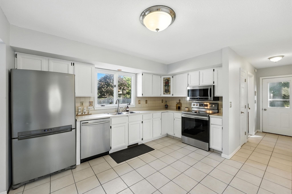 79 Stephanie Circle Springfield, MA 01129 - Photo 10 of 29 a kitchen with stainless steel appliances granite countertop a refrigerator sink and stove