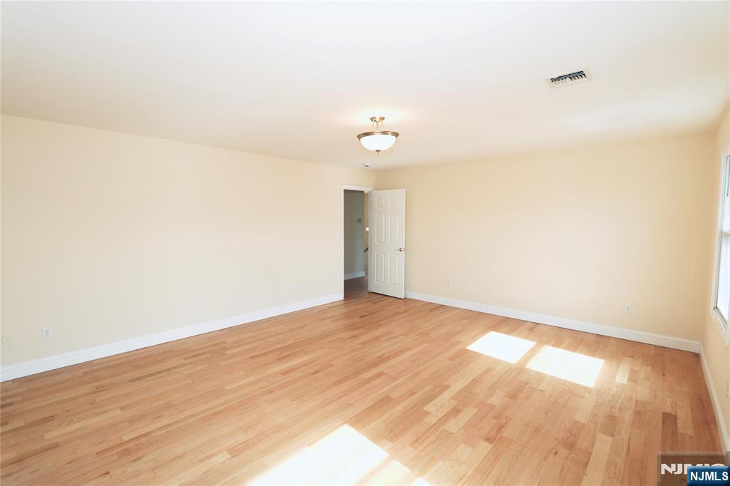 23 Main Avenue Wallington, NJ 07057 - Photo 21 of 29 a view of an empty room and wooden floor