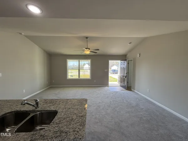 a view of a kitchen with a sink and a window
