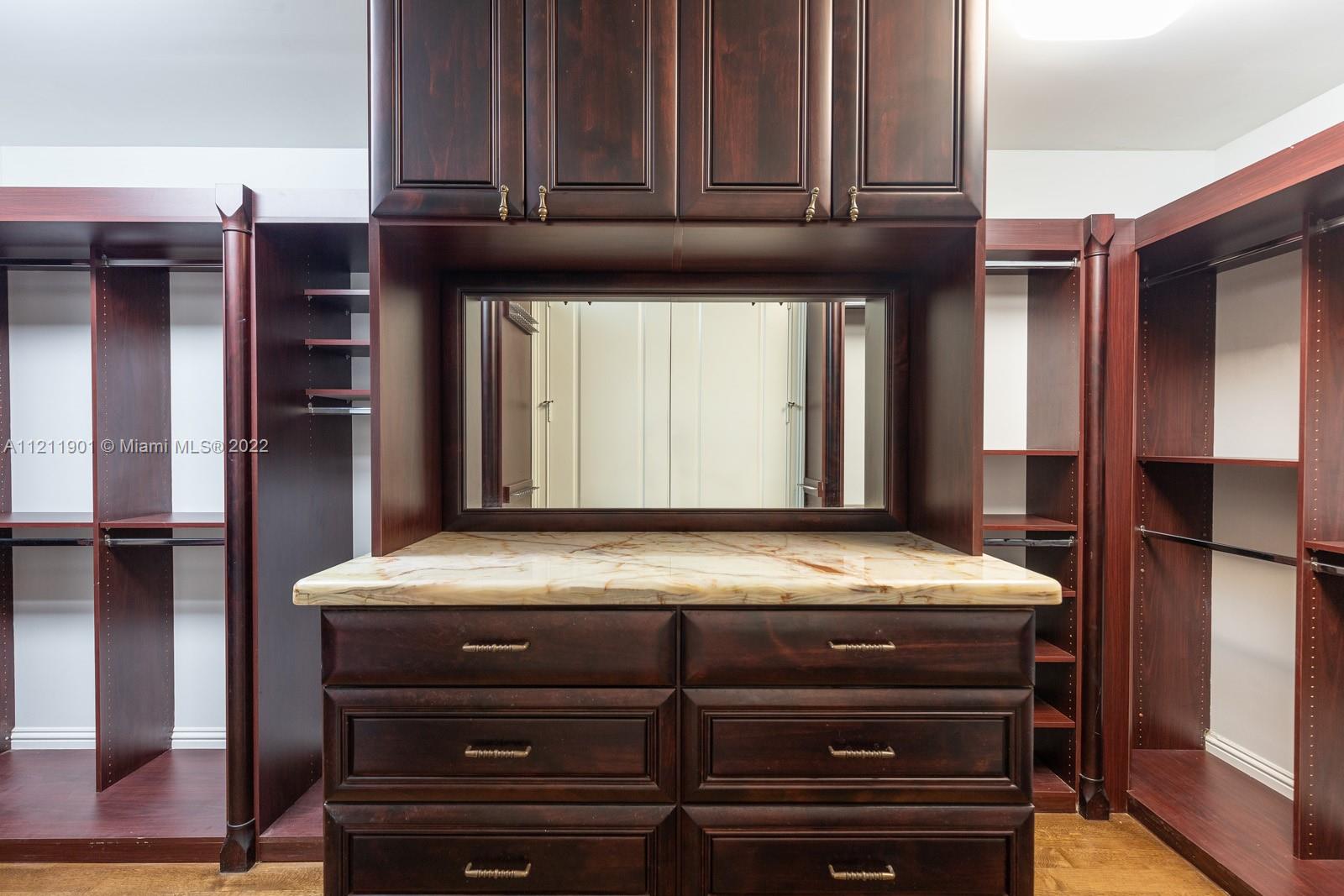 3471 Main Highway, Unit 928 Miami, FL 33133 - Photo 13 of 35 a kitchen with stainless steel appliances granite countertop a refrigerator and cabinets