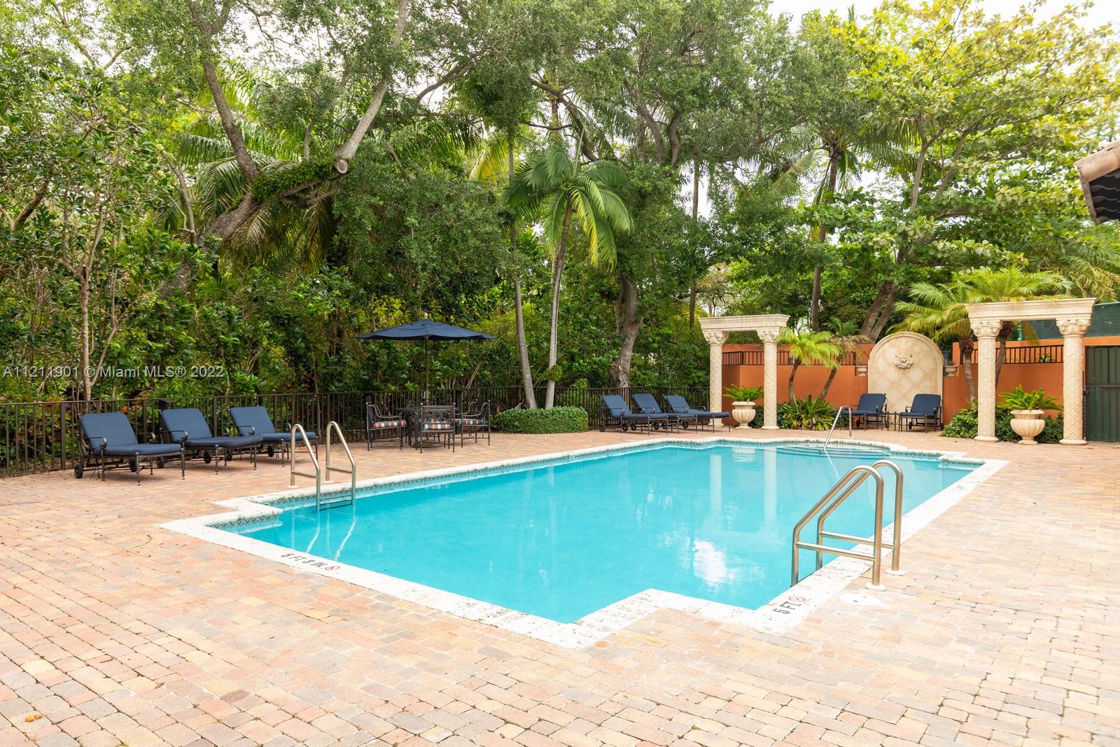 3471 Main Highway, Unit 928 Miami, FL 33133 - Photo 33 of 35 a view of a swimming pool with lounge chair